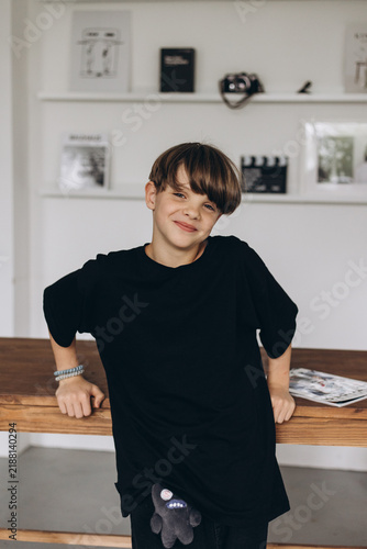 European teenager boy 11-12 years old. Boy model in a black T-shirt. Smiling