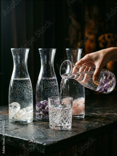 Elegant Glass Carafe Pouring Water into Drinking Glasses at Home