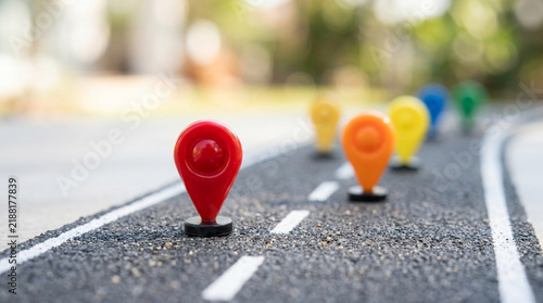 Colorful map pins on a miniature road, concept of journey, destination, travel