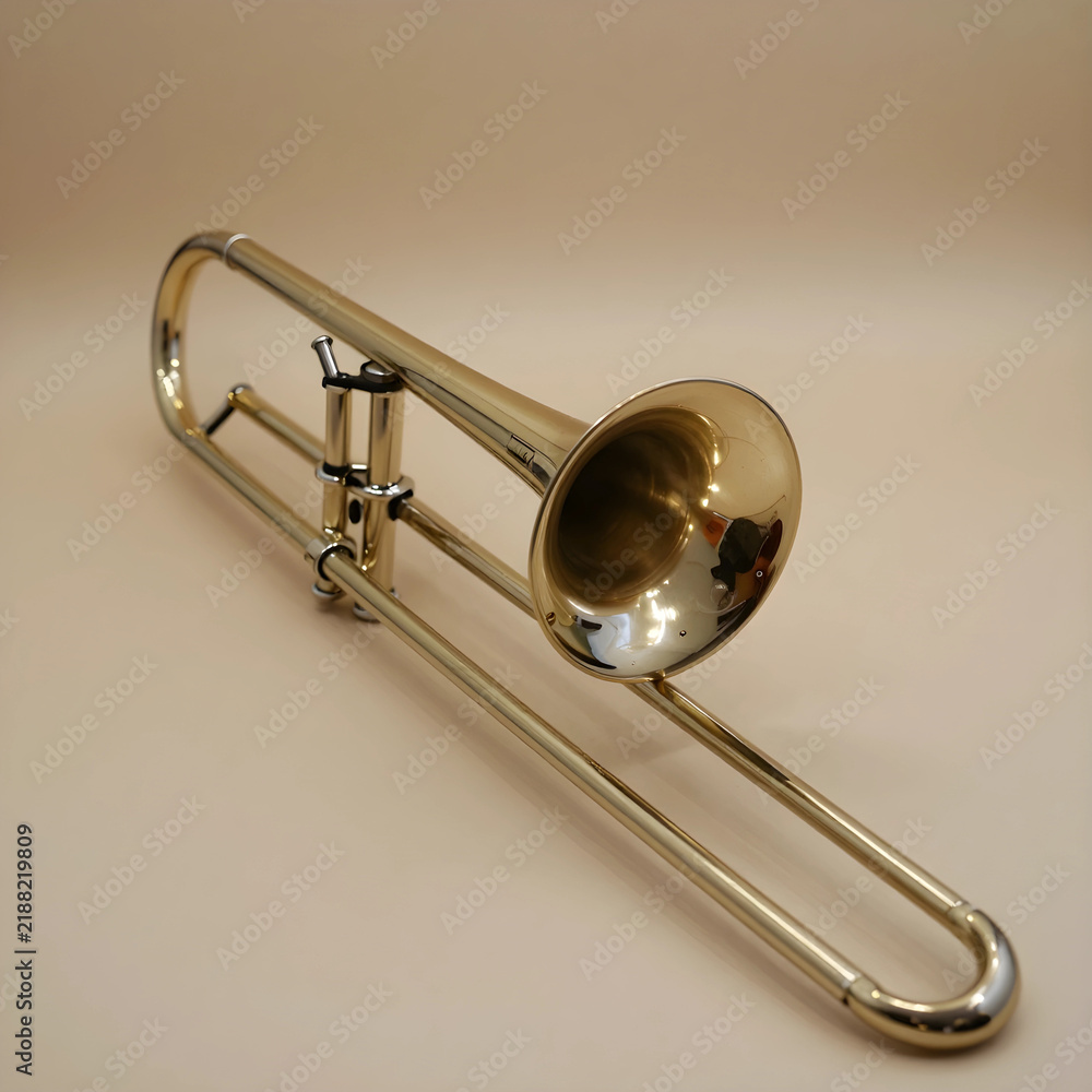 Obraz premium Music education and jazz performance, brass trombone instrument for orchestra and classical symphony concert on a neutral studio background