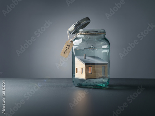 Plakat Tiny House Preserved Inside Glass Jar Symbolizing Housing Security
