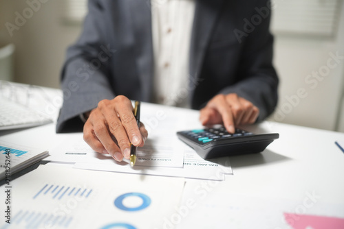 Bild auf Leinwand Businessman Calculating Finance and Writing Check