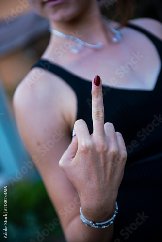 Fotografie Woman showing middle finger as rude obscene gesture
