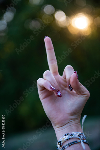 Bild auf Leinwand Female hand showing middle finger with nail art