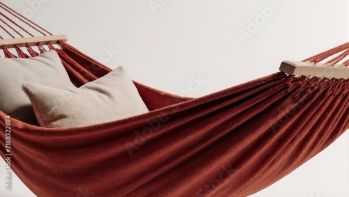 Comfortable red hammock with pillows for relaxation and leisure.