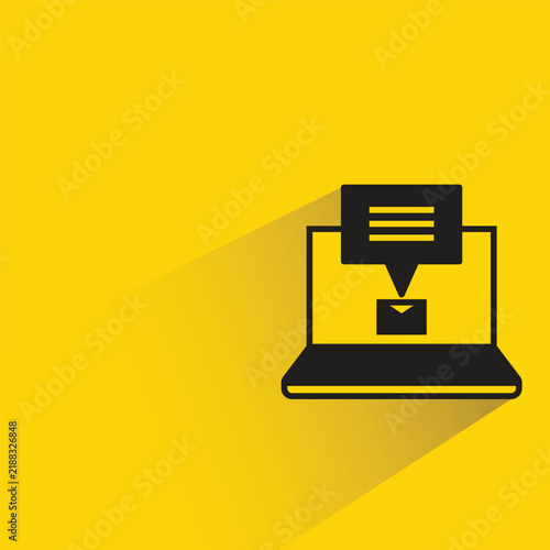 email message in laptop icon drop shadow on yellow background