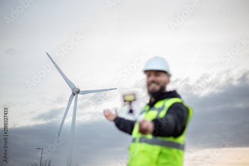 Engineer presenting wind energy data from a wind turbine site, promoting clean sustainable power