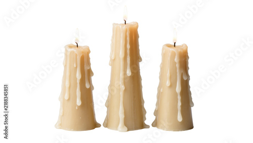 Obraz na płótnie Three tall beige taper candles with dripping wax, isolated on transparent backgr