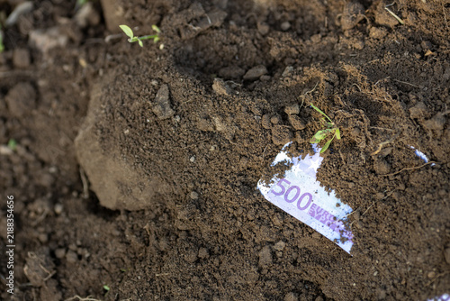 A 500 Euro Banknote Partially Covered by Soil