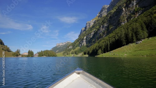 POV shot from boat bow floating on Seealpsee lake in Alpstein Switzerland