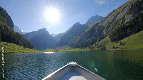 POV shot from boat bow floating on Seealpsee lake in Alpstein Switzerland