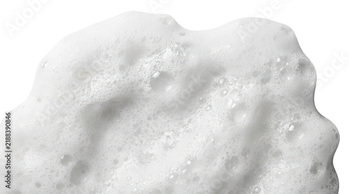 Close-up of creamy white soap foam texture with bubbles isolated on white background