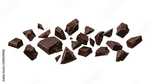 Fotografie Broken pieces of dark cocoa chocolate chunks scattered dynamically in air floati