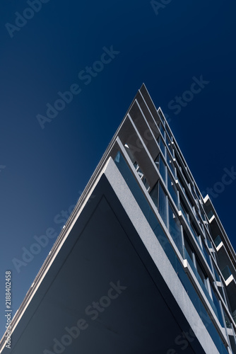bottom up architectural view on modern residential building against clear sky on sunny day, Abu Dhabi