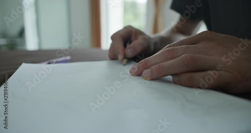 Male hand draw a drawing on sheet of paper. 4K 10-bit