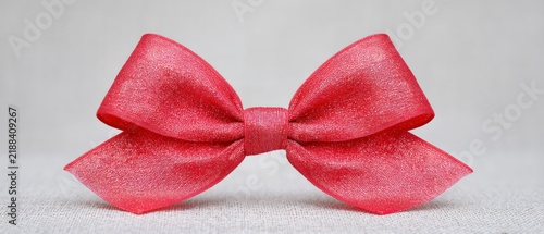 Beautiful red ribbon on a gentle backdrop ideal for wrapping gifts or engaging in craft activities suitable for festive celebrations special occasions and joyful events