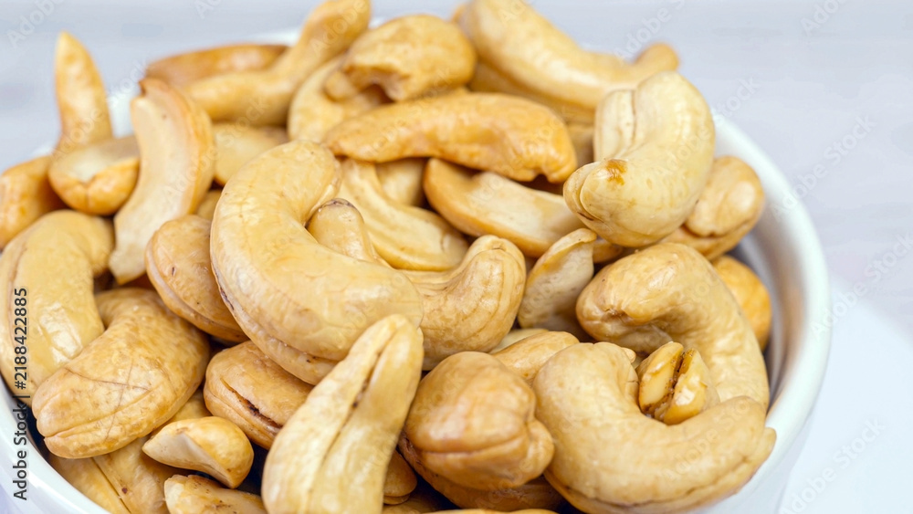 Fototapeta premium Fresh fried cashew nuts slowly rotating in a seamless loop
