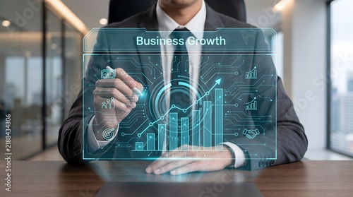 Businessman interacting with a futuristic holographic digital interface displaying complex financial data and growth charts
