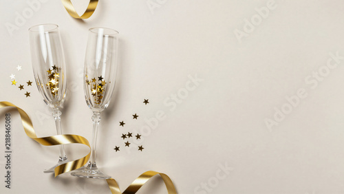 Minimalist Top Down Flat Lay Champagne Flutes and Gold Ribbons