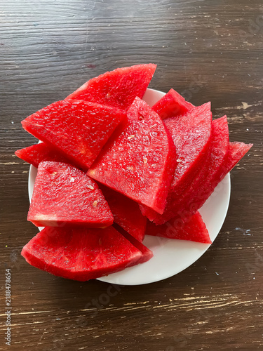 Top view of plate with sliced seedless watermelon, summer fruit and healthy eating