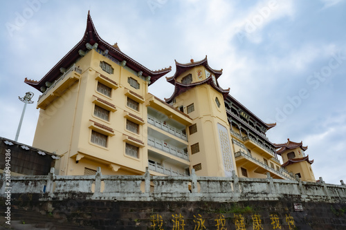 Low angle shot of traditional Chinese style multi-story building with upturned eaves under cloudy sky