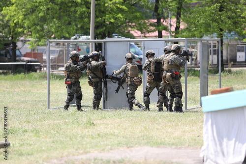 Armed special forces soldiers in camouflage tactical gear during a tactical combat exercise or combat operation