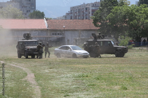 Armed special forces soldiers in camouflage tactical gear during a tactical combat exercise or combat operation