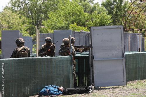 Armed special forces soldiers in camouflage tactical gear during a tactical combat exercise or combat operation