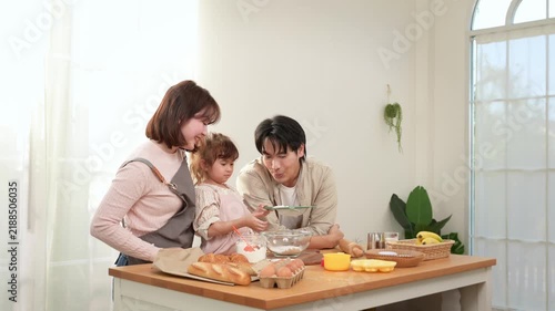 Family Enjoys Baking Together in a Bakery With a Girl Playing With Dough