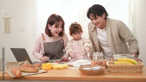 Family Enjoys Baking Together in a Bakery With a Girl Playing With Dough