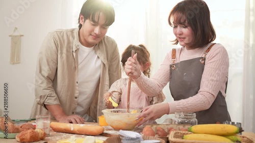 Family Enjoys Baking Together in a Bakery With a Girl Playing With Dough