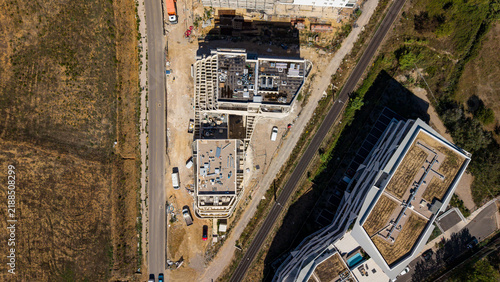 Принти на полотні Aerial view of a construction site beside a railway line and scrubland