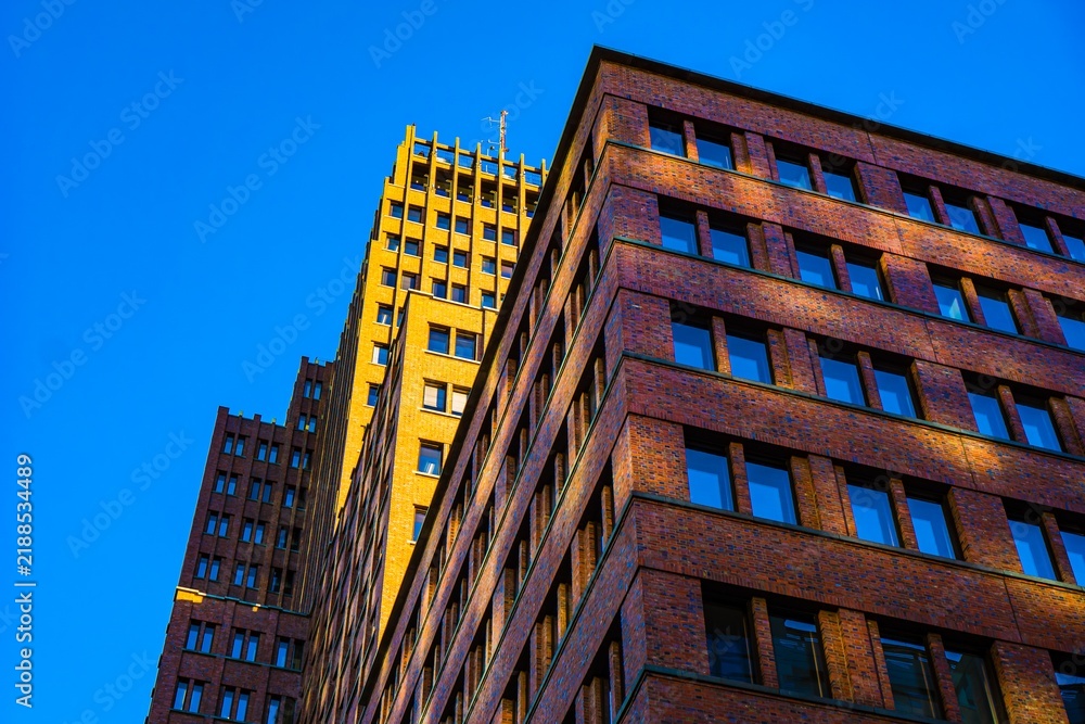 Fototapeta premium Modern brick buildings against a clear blue sky