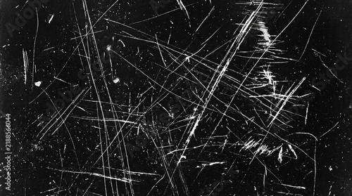 High contrast black and white texture with deep intersecting scratches and abrasions
