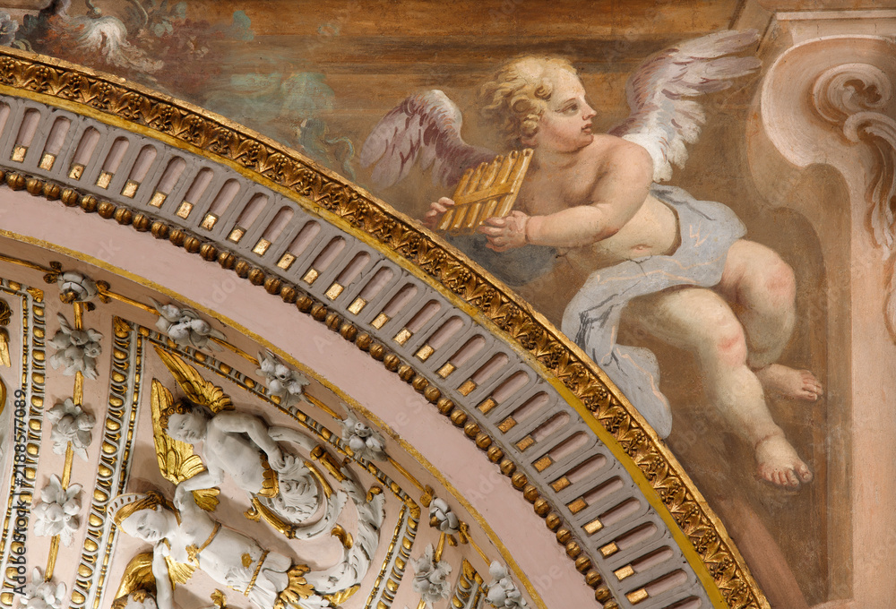 Fototapeta premium CREMA, ITALY - MARCH 20, 2026: The fresco of angel with the music instrument in the church Santuario di Santa Maria della Croce by Giacomo Parravicino from year 1702