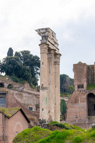 Картината върху платно Ancient Roman ruins with weathered columns and brick structures under a cloudy s