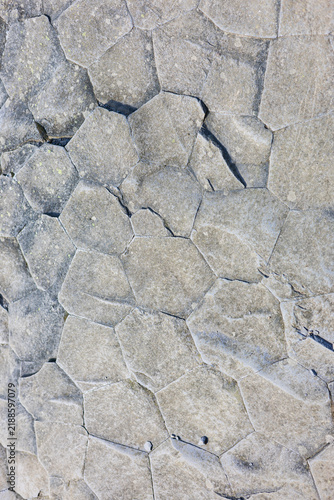 Natural grey stone pavement texture with hexagonal joints. stone wall texture