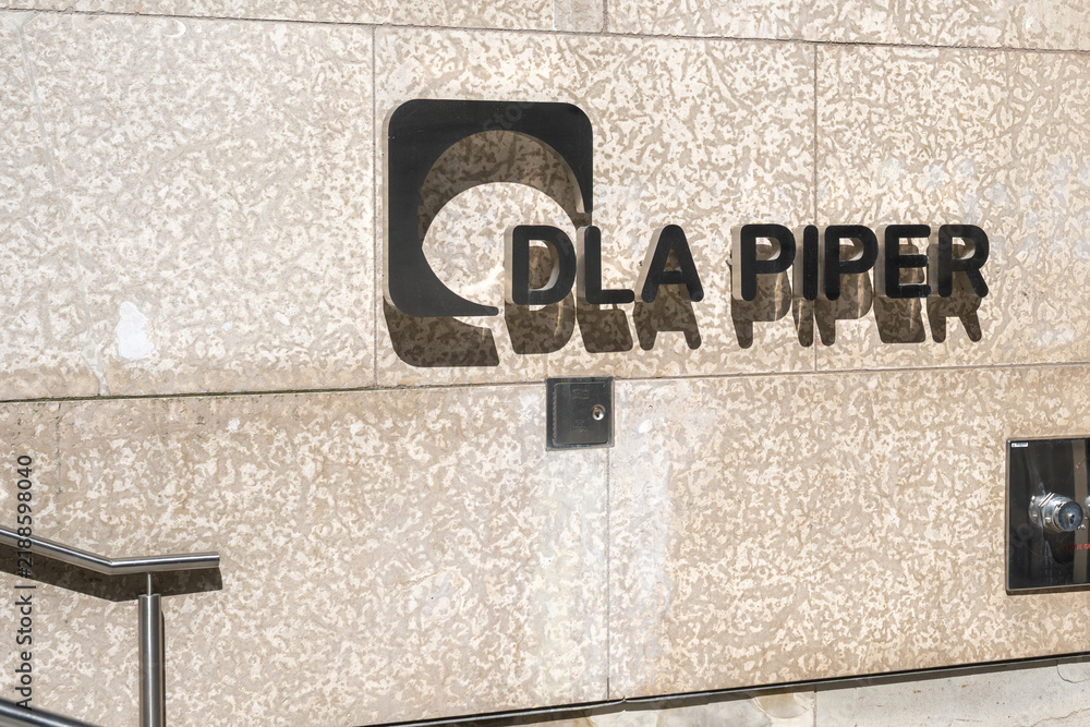 Fototapeta premium Toronto, Ontario, Canada - October 6, 2025: DLA Piper (Canada) law firm logo sign at the entrance to the office in downtown Toronto, Ontario, Canada. DLA Piper is a global law firm. 