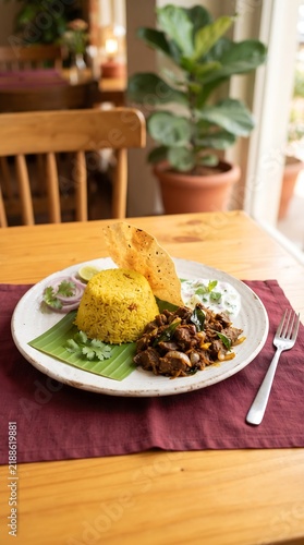 Traditional Rice and Curry Meal Served on Plate with Crispy Snacks