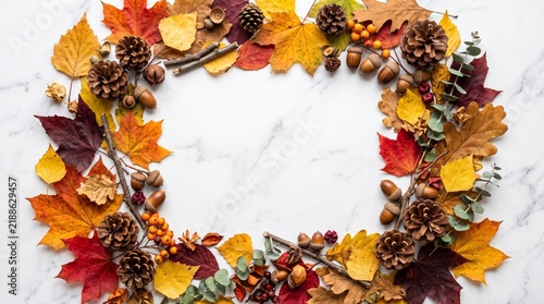 Autumn Flat Lay Frame with Pumpkins Pinecones and Foliage on White Marble