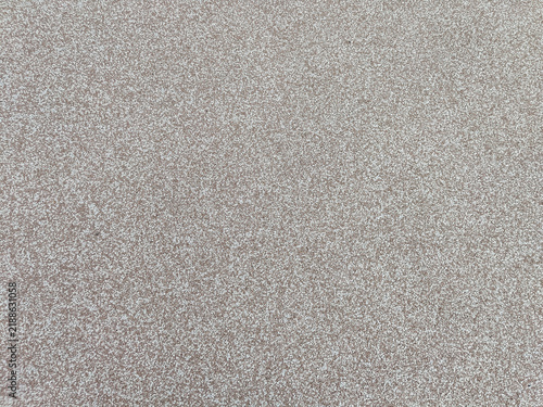 Textured wall background with fine-grained matte surface finish. Full frame. Design.