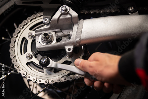 Mechanic Repairing Motorcycle With Wrench in Close Up