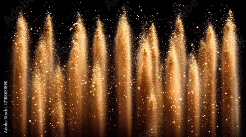 Golden dust swirls gracefully against a dark backdrop sparkling like stars in the sky