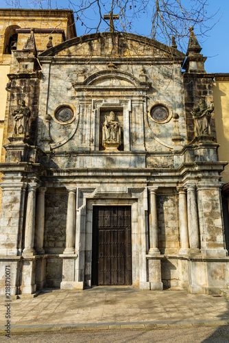 Facade of the Sanctuary of the Holy Christ of the Agony, decorated with columns, carvings, and statues. Limpias, Cantabria, Spain.