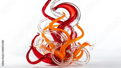 Vibrant abstract glass sculpture with swirling red and orange organic shapes on white background