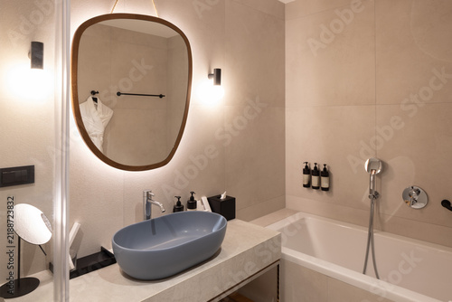 Modern luxury bathroom interior with oval sink mirror and bathtub
