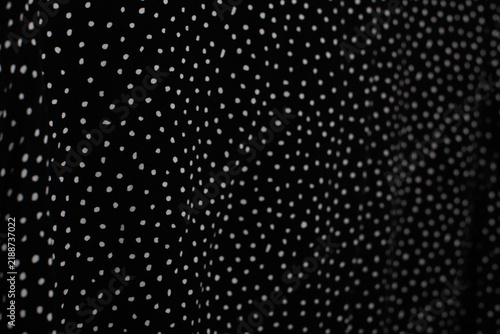 Black fabric texture with small white polka dot pattern