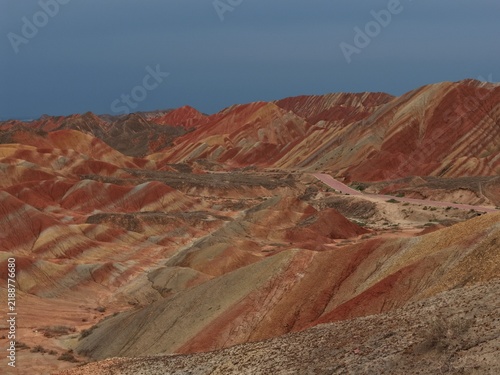 Фотография Colorful Zhangye Danxia mountains in Gansu, China, featuring layered rainbow rock formations, dramatic desert scenery and striking geology in a famous Danxia geopark