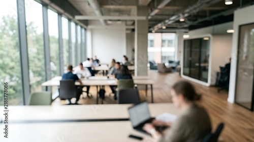Defocused modern open plan office interior background with people working