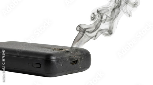 Cuadro en lienzo Damaged portable power bank emitting smoke from a burnt port